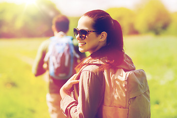 Image showing happy couple with backpacks hiking outdoors