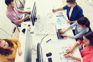 Image showing creative team with computers, blueprint at office