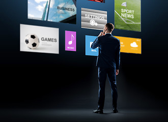 Image showing businessman looking at virtual applications