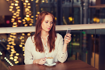 Image showing woman with smartphone and coffee at restaurant