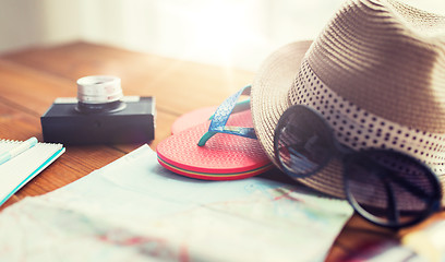 Image showing close up of travel map, flip-flops, hat and camera