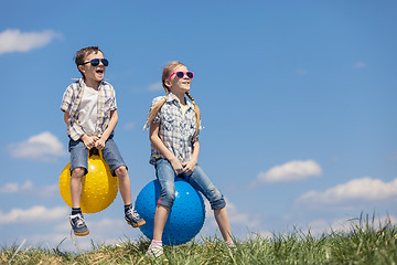 Image showing Brother and sister playing on the field at the day time.