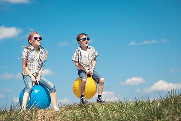 Image showing Brother and sister playing on the field at the day time.