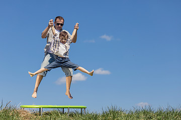 Image showing Father and son playing on the field at the day time.