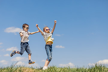 Image showing Brother and sister playing on the field at the day time.