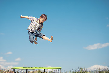 Image showing Little boy playing on the field at the day time.