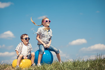 Image showing Brother and sister playing on the field at the day time.