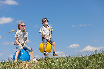 Image showing Brother and sister playing on the field at the day time.