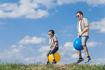 Image showing Father and son playing on the field at the day time.