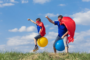 Image showing Father and son playing superhero at the day time.