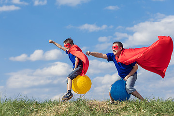 Image showing Father and son playing superhero at the day time.