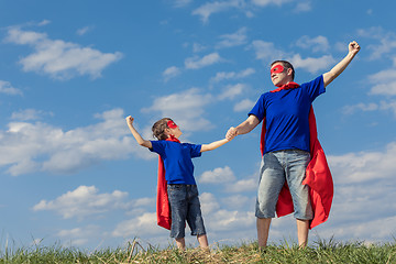 Image showing Father and son playing superhero at the day time. 