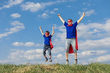 Image showing Father and son playing superhero at the day time.