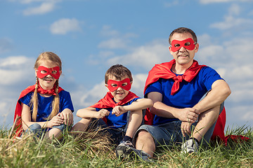 Image showing Father and children playing superhero at the day time.