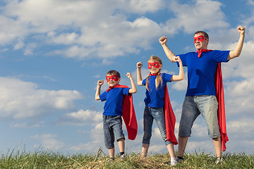 Image showing Father and children playing superhero at the day time.