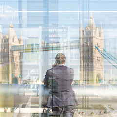 Image showing British businessman talking on mobile phone in London city, UK.