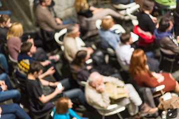 Image showing Blured audience in conference hall shot from abowe.