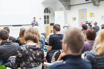 Image showing Man giving presentation in lecture hall at university.