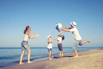 Image showing Happy family walking on the beach at the day time.