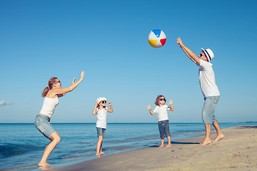 Image showing Happy family walking on the beach at the day time.