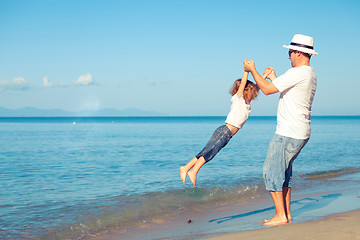 Image showing Father and son playing on the beach at the day time.