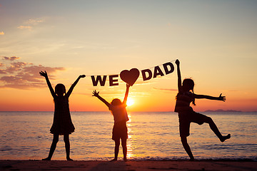 Image showing Happy children playing on the beach at the sunset time.