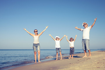 Image showing Happy family walking on the beach at the day time.