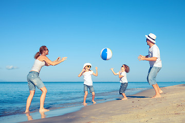 Image showing Happy family walking on the beach at the day time.