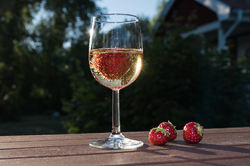 Image showing Sparkling wine and strawberries in a garden
