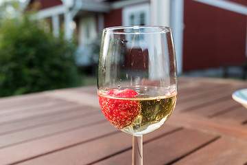 Image showing Glass with a strawberry in sparkling wine