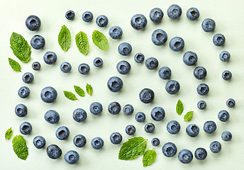 Image showing fresh blueberries on light green paper background