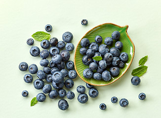 Image showing blueberries on green paper background