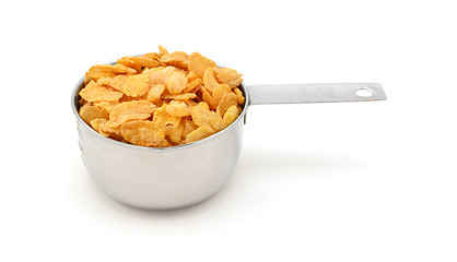 Image showing Corn flakes breakfast cereal in a measuring cup