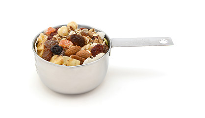 Image showing Muesli cereal with fruit and nuts in a measuring cup