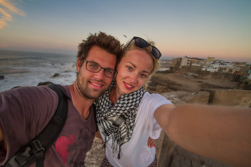 Image showing Traveler couple taking selfie on city fortress wall of Essaouira, Morocco.