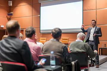 Image showing Business speaker giving a talk at business conference event.