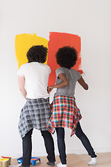 Image showing multiethnic couple painting interior wall