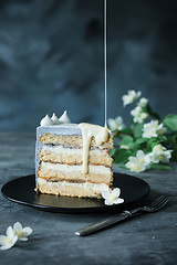 Image showing Slice of Birthday Cake with a flowers over a blue background.