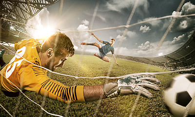 Image showing Goalkeeper in gates jumping to catching ball