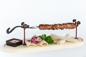 Image showing Close Up of Rack of Saucy Barbecue Pork Served on Plate in Restaurant