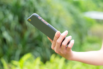 Image showing Young woman using cellphone outdoor