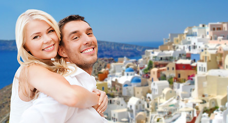 Image showing happy couple hugging over santorini island