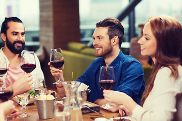 Image showing friends dining and drinking wine at restaurant