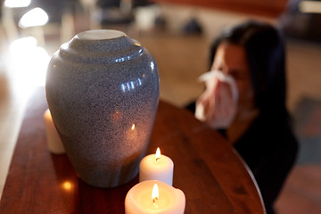 Image showing woman with cremation urn at funeral in church