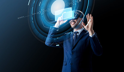 Image showing businessman in virtual reality headset over black