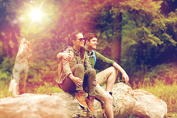 Image showing smiling couple with backpacks in nature