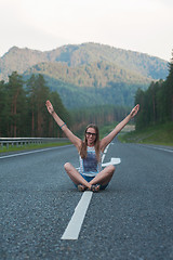 Image showing Woman sitting on the road