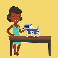 Image showing Happy young woman playing with robotic dog.