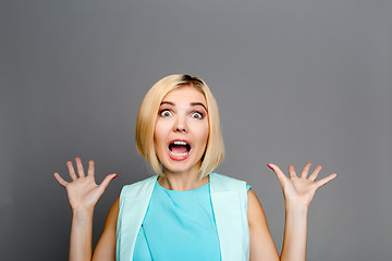 Image showing Beautiful blonde with raised hands