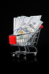 Image showing Photo of trolley with dollars